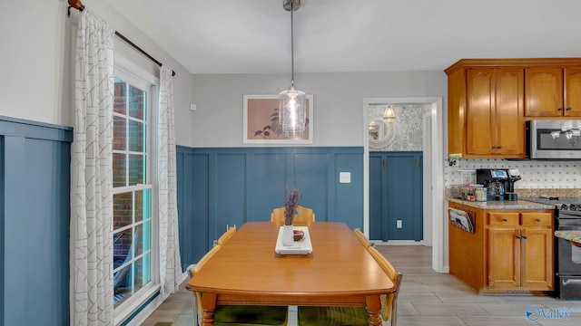 2317 Little Cove Rd, Owens Cross Roads, AL 35763 - dining area with a decorative wall and a wainscoted wall