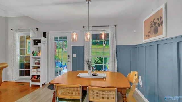 2317 Little Cove Rd, Owens Cross Roads, AL 35763 - dining space with wood finished floors, a decorative wall, and wainscoting