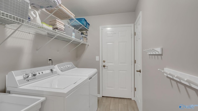 2317 Little Cove Rd, Owens Cross Roads, AL 35763 - washroom with washer and clothes dryer and light wood-style floors