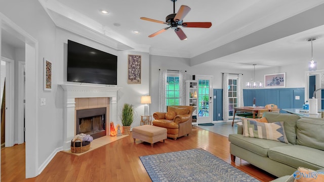 2317 Little Cove Rd, Owens Cross Roads, AL 35763 - living room featuring ceiling fan, wood finished floors, a tiled fireplace, ornamental molding, and recessed lighting