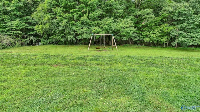 2317 Little Cove Rd, Owens Cross Roads, AL 35763 - view of grassy yard featuring a playground and a view of trees