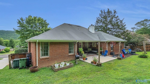 2317 Little Cove Rd, Owens Cross Roads, AL 35763 - back of property featuring brick siding, a patio, and a chimney