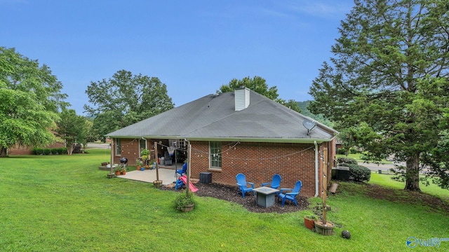 2317 Little Cove Rd, Owens Cross Roads, AL 35763 - rear view of house featuring a patio, a yard, brick siding, and a chimney