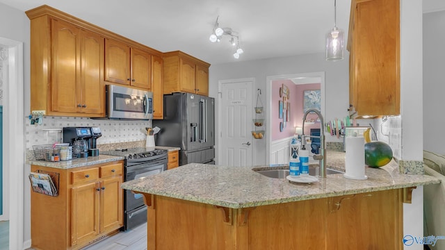 2317 Little Cove Rd, Owens Cross Roads, AL 35763 - kitchen with appliances with stainless steel finishes, a peninsula, a kitchen breakfast bar, light stone counters, and tasteful backsplash