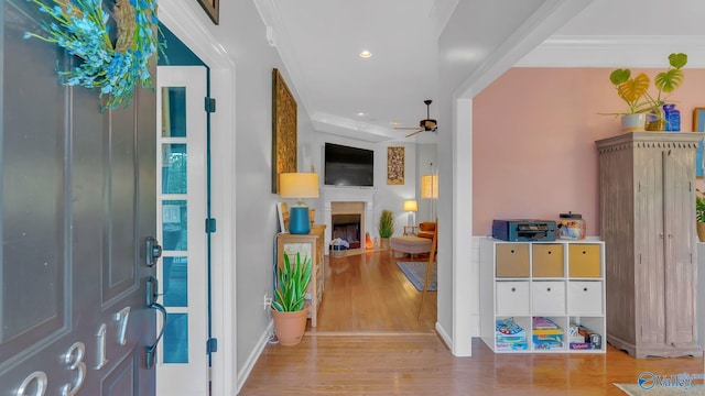 2317 Little Cove Rd, Owens Cross Roads, AL 35763 - foyer entrance featuring wood finished floors, ceiling fan, a fireplace, ornamental molding, and recessed lighting