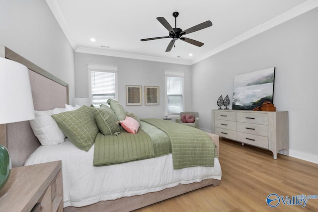 bedroom featuring crown molding, light hardwood / wood-style flooring, and ceiling fan