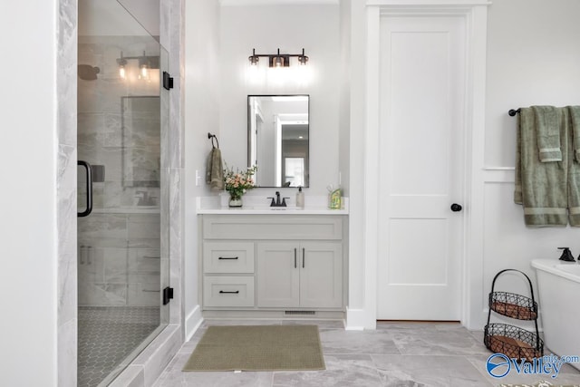 bathroom featuring tile patterned floors, a shower with shower door, and vanity