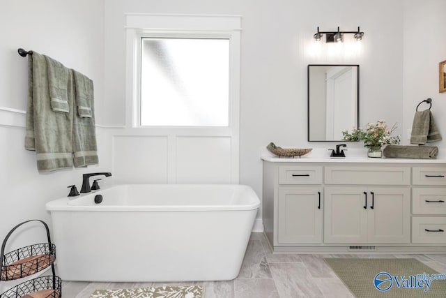 bathroom with vanity, a bath, and tile patterned floors