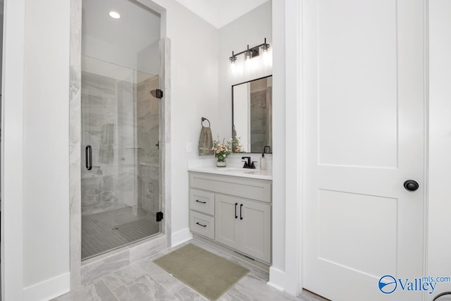 bathroom featuring tile patterned floors, a shower with door, and vanity