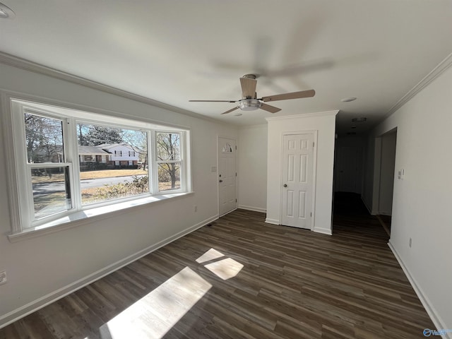 unfurnished bedroom featuring ornamental molding, dark wood-type flooring, ceiling fan, and baseboards