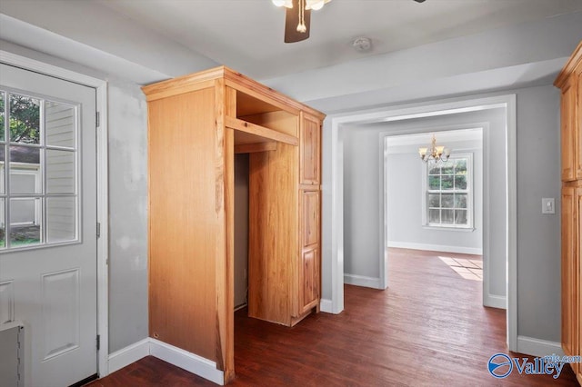 interior space with a chandelier and dark hardwood / wood-style flooring