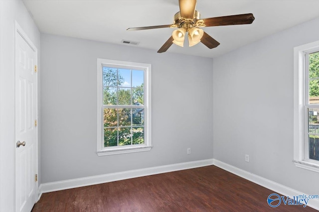 empty room with ceiling fan and dark wood-type flooring