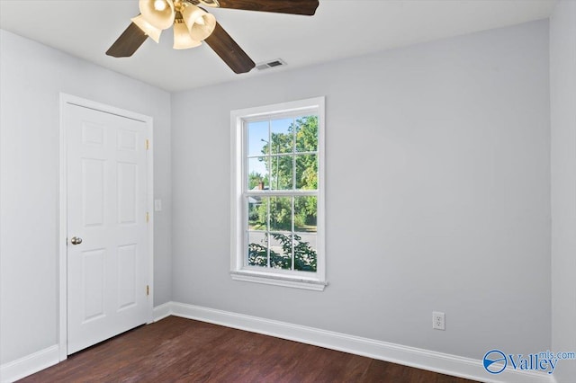 spare room with dark hardwood / wood-style floors and ceiling fan