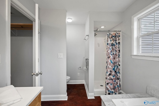 bathroom featuring a shower with curtain, toilet, baseboards, vanity, and wood finished floors