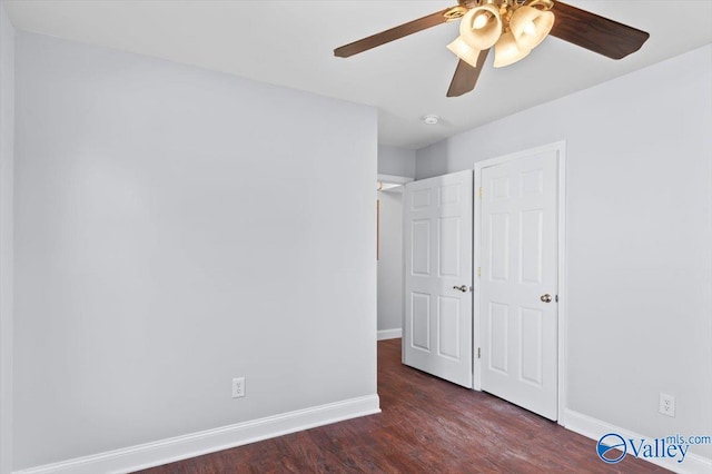 unfurnished bedroom featuring ceiling fan and dark wood-type flooring