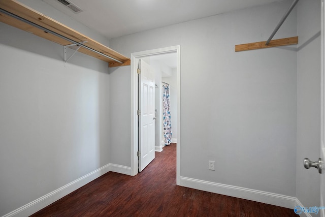 walk in closet featuring dark wood-style flooring and visible vents