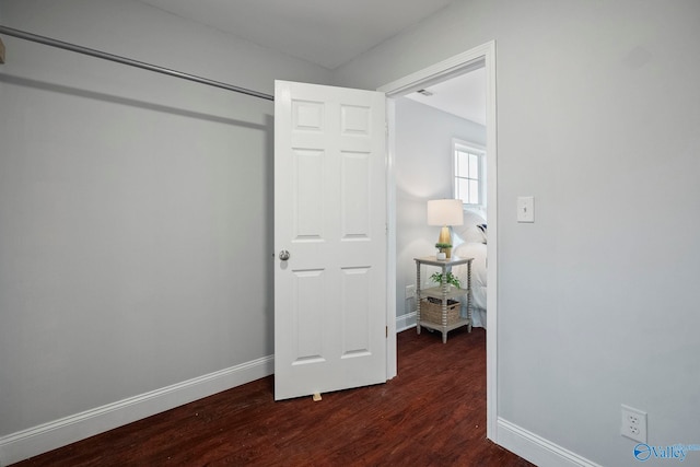 bedroom with baseboards and dark wood-style floors
