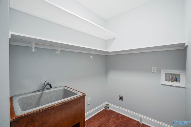clothes washing area featuring a sink, laundry area, electric dryer hookup, washer hookup, and baseboards