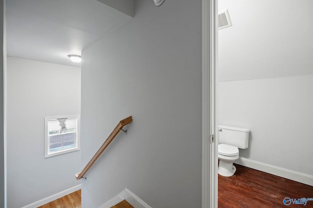 bathroom with toilet, baseboards, visible vents, and wood finished floors