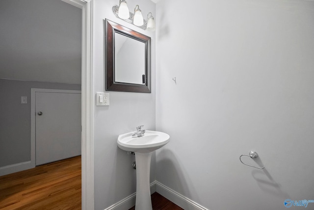 bathroom featuring wood finished floors and baseboards