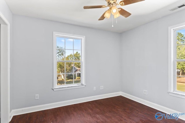 unfurnished room with hardwood / wood-style floors, a wealth of natural light, and ceiling fan