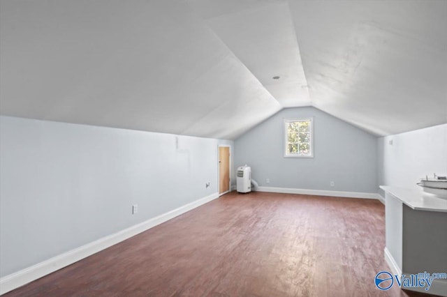 bonus room with lofted ceiling and wood-type flooring