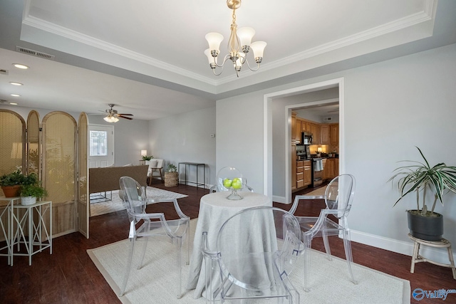 dining room featuring crown molding, visible vents, and wood finished floors