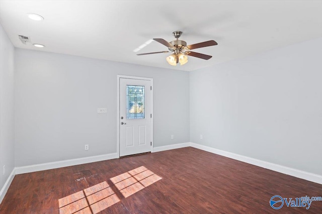 unfurnished room with ceiling fan and dark hardwood / wood-style flooring