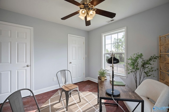 office area with wood finished floors, visible vents, baseboards, and ceiling fan