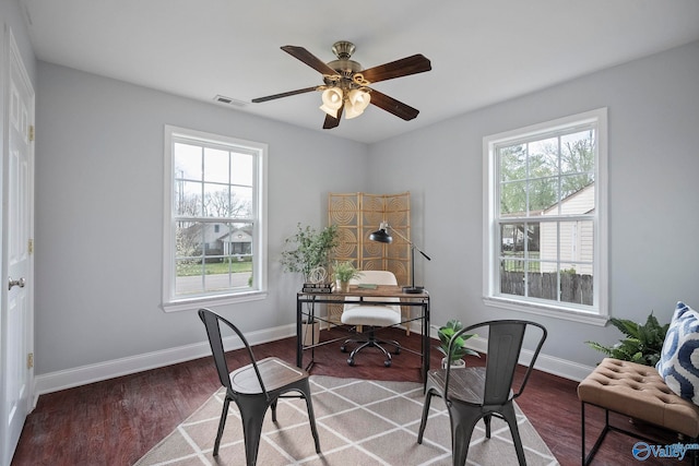 office space with a ceiling fan, baseboards, visible vents, and wood finished floors