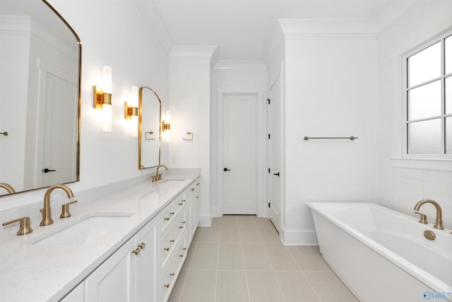 bathroom with a tub to relax in, tile patterned floors, ornamental molding, and vanity