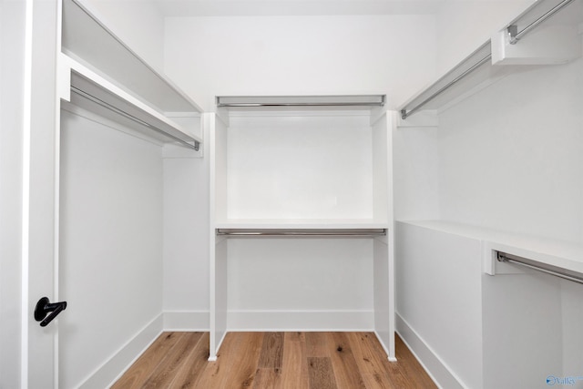 walk in closet featuring light hardwood / wood-style flooring