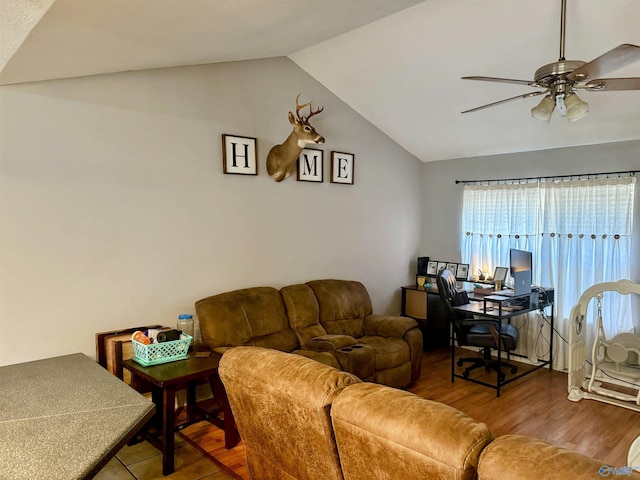 living room featuring hardwood / wood-style flooring, ceiling fan, and lofted ceiling