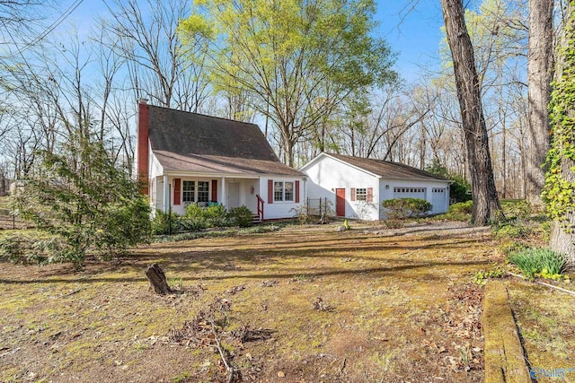 view of front of house with an outbuilding and a detached garage