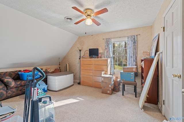 bedroom featuring a textured ceiling, carpet, and a ceiling fan