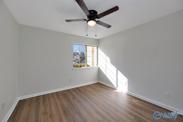 unfurnished room with ceiling fan and wood-type flooring