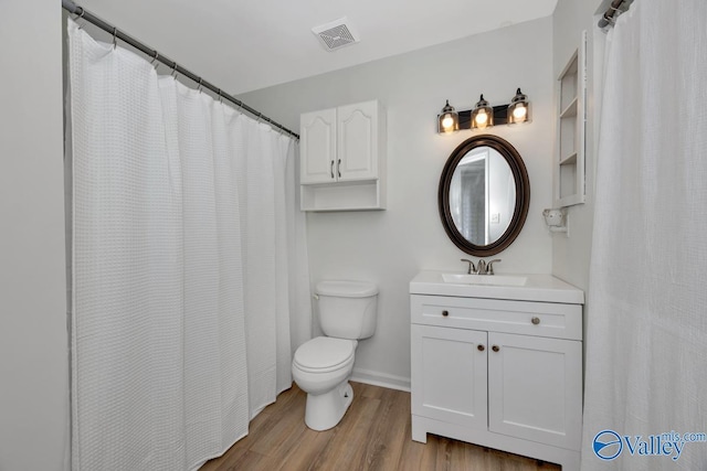 bathroom featuring hardwood / wood-style floors, vanity, and toilet