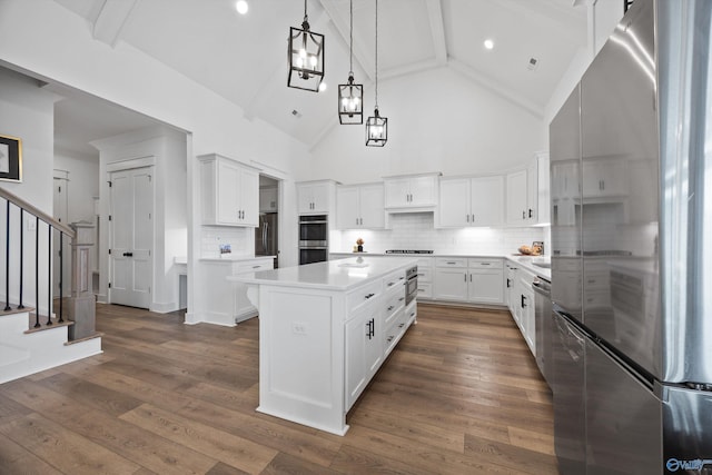 kitchen featuring white cabinetry, appliances with stainless steel finishes, a center island, and dark hardwood / wood-style floors