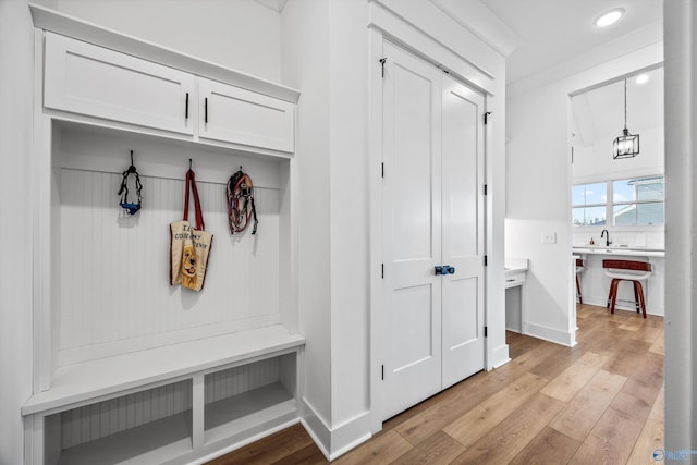 mudroom featuring sink and light hardwood / wood-style flooring