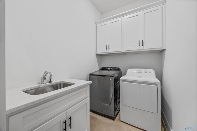 laundry room with sink, cabinets, independent washer and dryer, and light tile patterned flooring