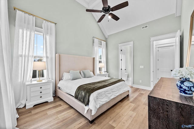 bedroom featuring high vaulted ceiling, multiple windows, and light hardwood / wood-style flooring