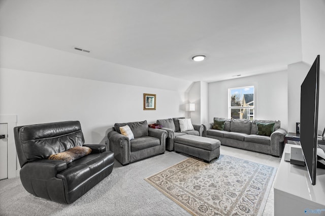 living room featuring lofted ceiling