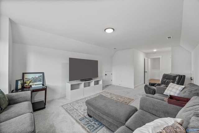 carpeted living room featuring vaulted ceiling