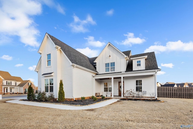 modern farmhouse with covered porch and a front yard