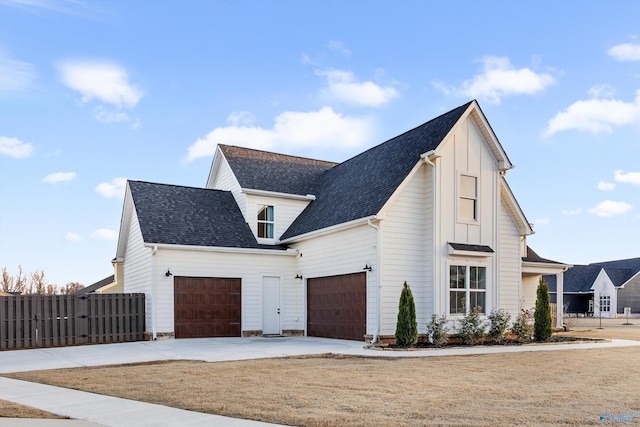 view of front of house featuring a garage and a front lawn