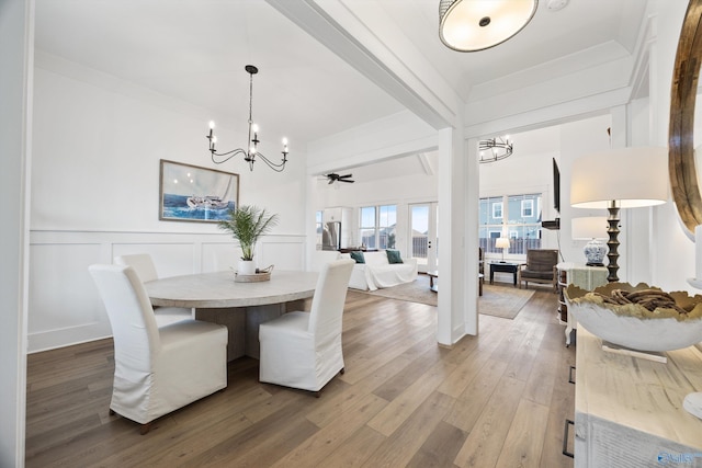 dining room featuring hardwood / wood-style floors, ceiling fan with notable chandelier, and ornamental molding