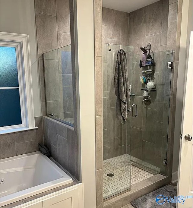 bathroom with shower with separate bathtub