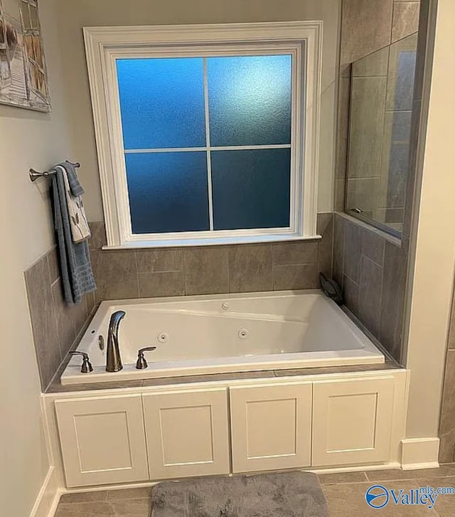 bathroom featuring a relaxing tiled tub