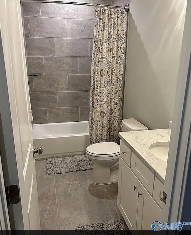 full bathroom featuring tile patterned floors, vanity, toilet, and shower / bathtub combination with curtain