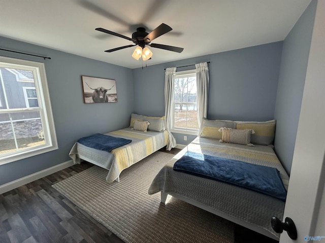 bedroom with dark hardwood / wood-style floors and ceiling fan